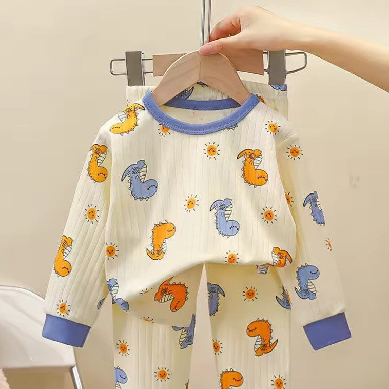 Pyjama bébé blanc motif dinosaures colorés et soleils finitions bleues